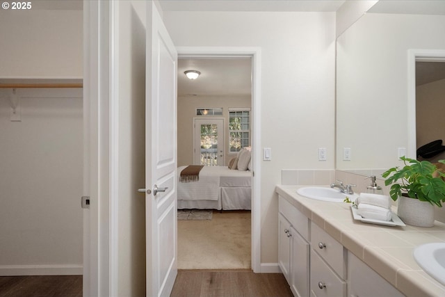 bathroom with vanity and hardwood / wood-style flooring