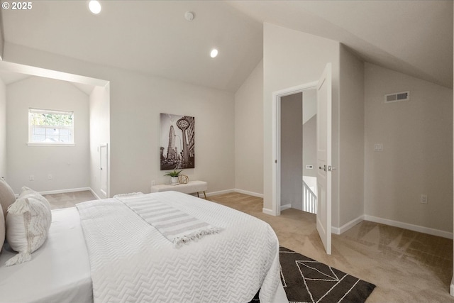 bedroom with light carpet and vaulted ceiling