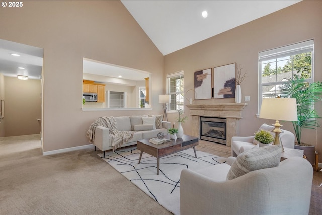 living room featuring high vaulted ceiling and light colored carpet