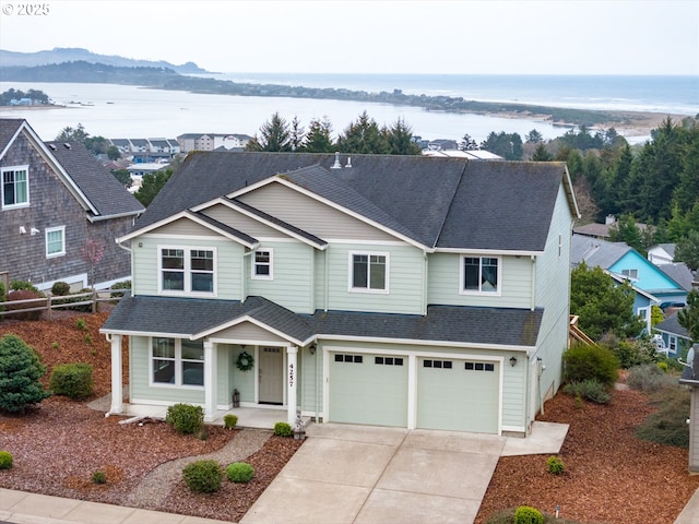 4257 SE Jetty Ave, Lincoln City, OR 97367 - traditional-style home featuring concrete driveway, a water view, a shingled roof, a porch, and a garage