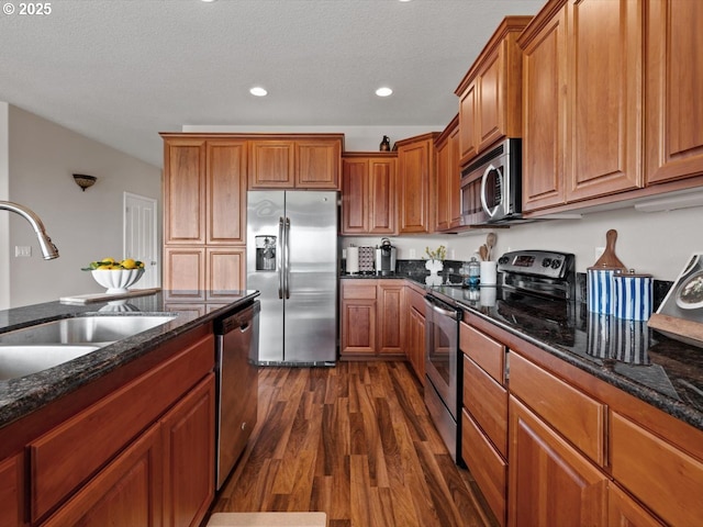4257 SE Jetty Ave, Lincoln City, OR 97367 - kitchen featuring brown cabinets, a sink, appliances with stainless steel finishes, dark wood-style floors, and recessed lighting