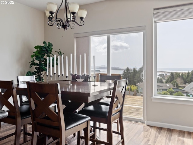4257 SE Jetty Ave, Lincoln City, OR 97367 - dining area featuring baseboards, a notable chandelier, and light wood finished floors