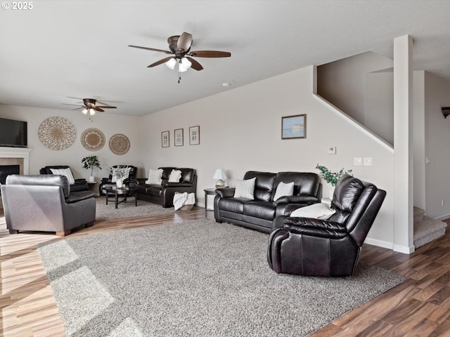 4257 SE Jetty Ave, Lincoln City, OR 97367 - living area with wood finished floors, stairs, a fireplace, baseboards, and a ceiling fan