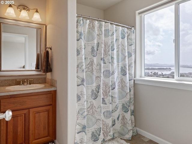 4257 SE Jetty Ave, Lincoln City, OR 97367 - bathroom featuring curtained shower, vanity, tile patterned flooring, and baseboards