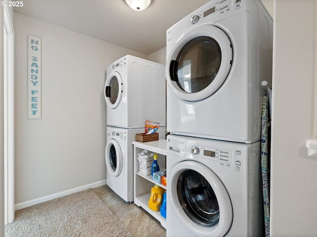 4257 SE Jetty Ave, Lincoln City, OR 97367 - laundry area with stacked washer / drying machine, laundry area, and baseboards