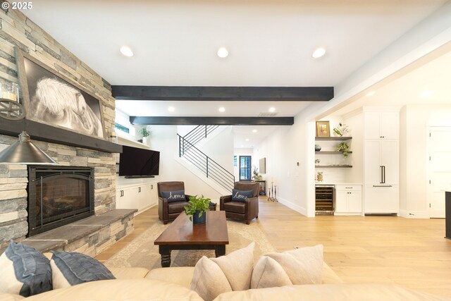 1931 13th St, West Linn, OR 97068 - living area with beverage cooler, a bar, light wood-type flooring, recessed lighting, and a stone fireplace