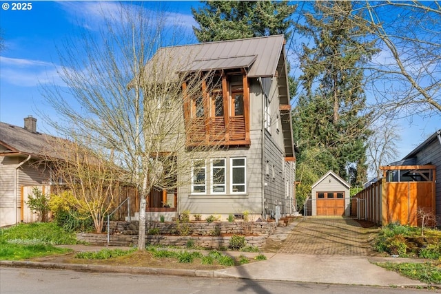 8316 SE 7th Ave, Portland, OR 97202 - view of front of house with an outdoor structure, a garage, metal roof, and a standing seam roof