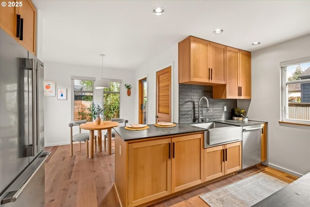 8316 SE 7th Ave, Portland, OR 97202 - kitchen featuring stainless steel appliances, dark countertops, a sink, healthy amount of natural light, and recessed lighting