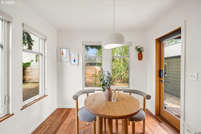 dining area with plenty of natural light and light wood-style flooring