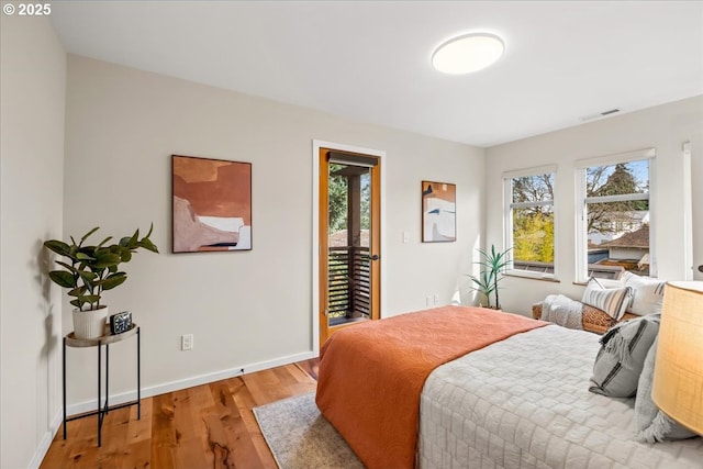 8316 SE 7th Ave, Portland, OR 97202 - bedroom featuring access to exterior, light wood finished floors, and baseboards