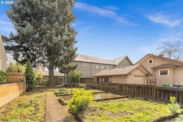 view of yard featuring a fenced backyard and a garage