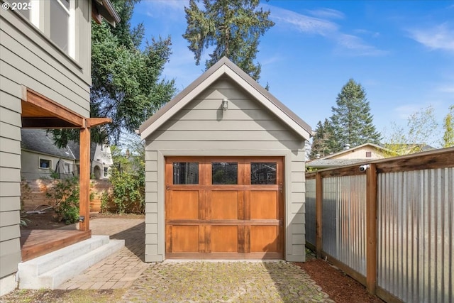 view of outbuilding with fence and an outbuilding