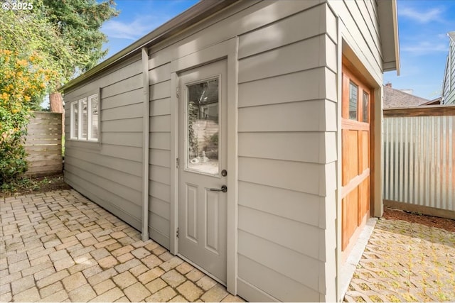 view of outbuilding featuring fence