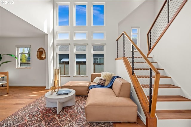 8316 SE 7th Ave, Portland, OR 97202 - living room with wood finished floors, stairway, baseboards, and a high ceiling