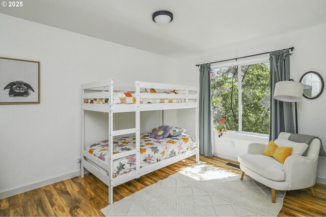 bedroom featuring wood finished floors and baseboards