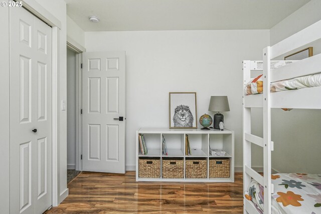 bedroom featuring wood finished floors and a closet