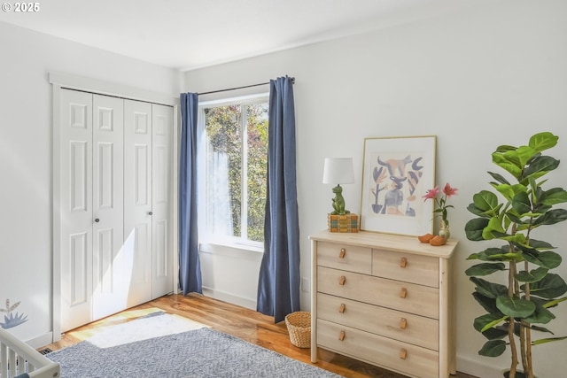 bedroom with a closet and light wood-style floors