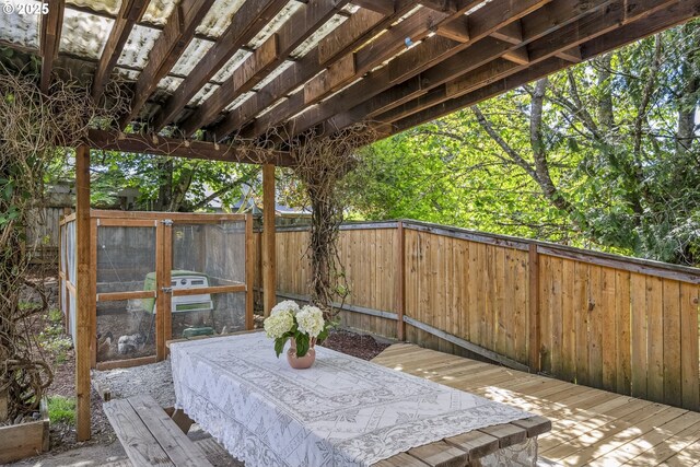 wooden deck featuring a fenced backyard and exterior structure