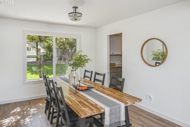 dining area featuring baseboards and wood finished floors