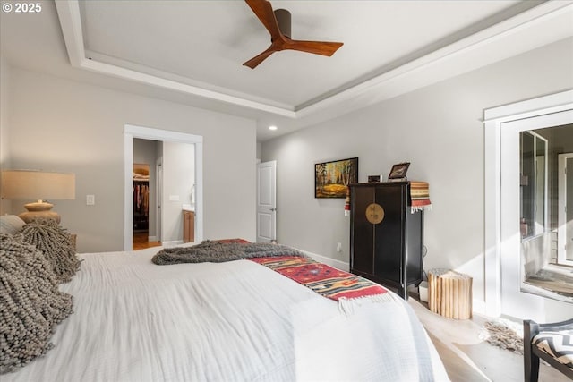 carpeted bedroom with recessed lighting, connected bathroom, a raised ceiling, and ceiling fan