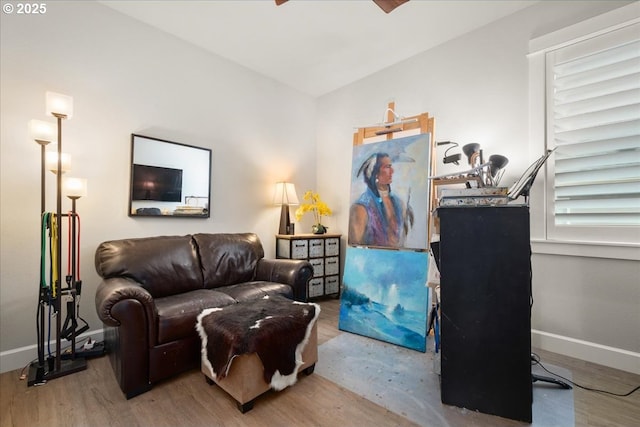 living area featuring wood finished floors and baseboards