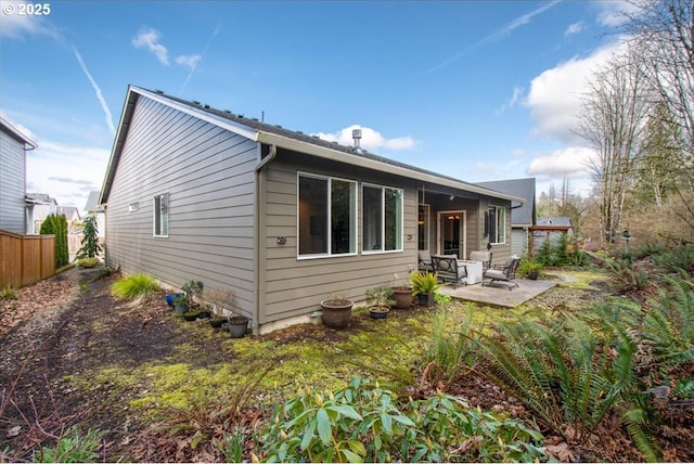 back of house featuring a patio and fence