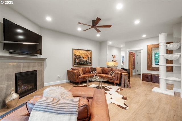 living room featuring recessed lighting, a tile fireplace, ceiling fan, and wood finished floors