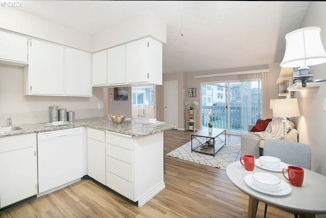 kitchen with white cabinetry, kitchen peninsula, light wood-type flooring, and dishwasher