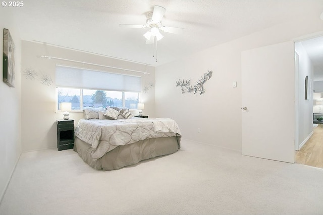 carpeted bedroom featuring a textured ceiling and ceiling fan