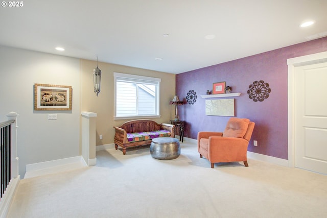 living area featuring light carpet