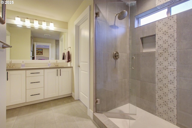 bathroom with vanity, tile patterned floors, and a shower with shower door