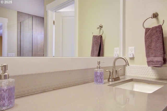 bathroom with vanity and tasteful backsplash