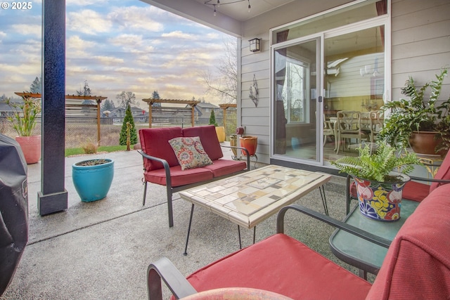 patio terrace at dusk featuring an outdoor hangout area