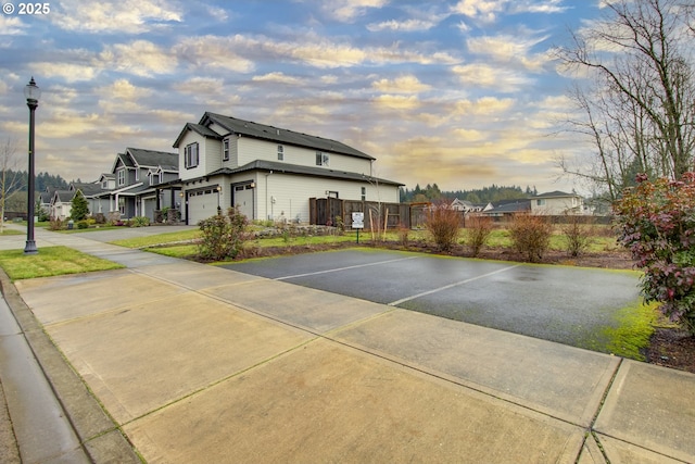 property exterior at dusk featuring a garage