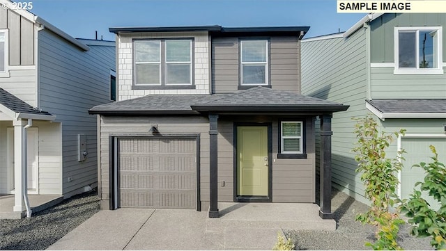 view of front of house featuring a shingled roof, concrete driveway, and an attached garage