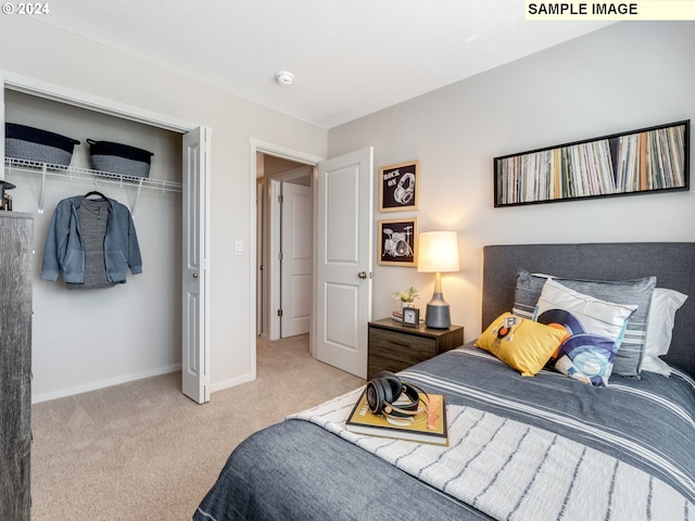 bedroom with a closet, light carpet, and baseboards