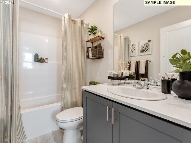 bathroom featuring toilet, shower / tub combo, wood finished floors, and vanity