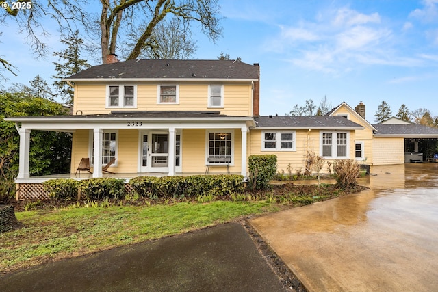 view of front of property featuring a porch and a chimney