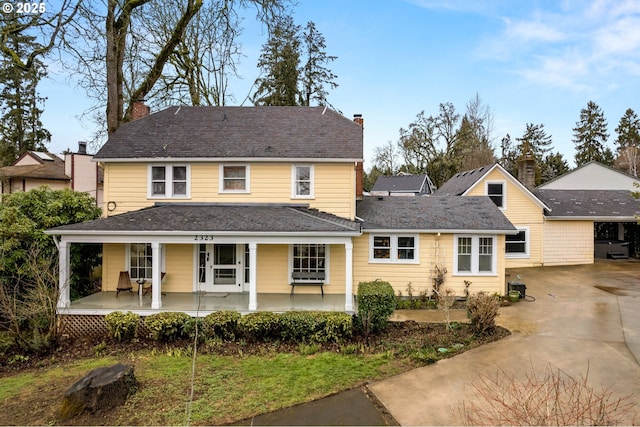 view of front of property with a porch and a chimney