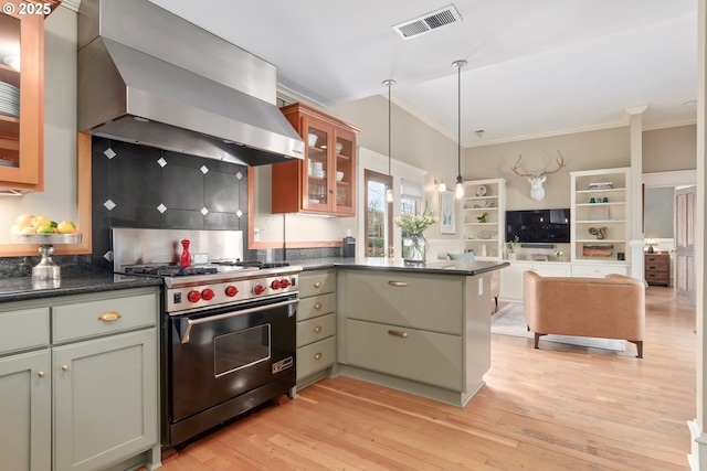 kitchen with a peninsula, light wood-style flooring, high end stainless steel range, wall chimney range hood, and open floor plan