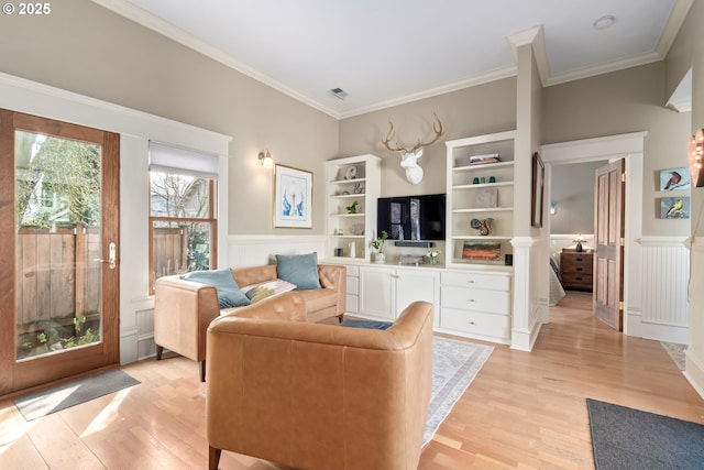 living room with visible vents, light wood-style flooring, and crown molding