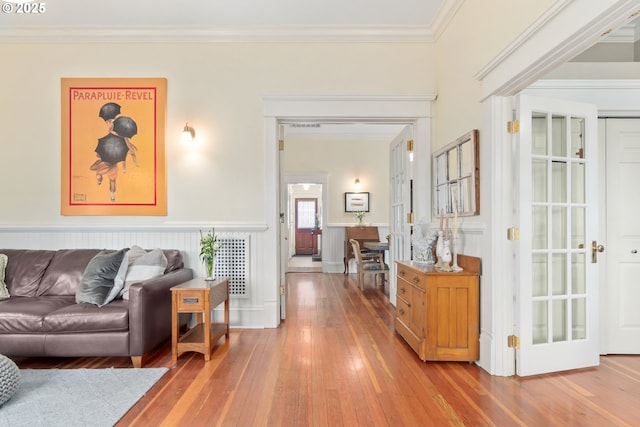 hall with hardwood / wood-style flooring and ornamental molding