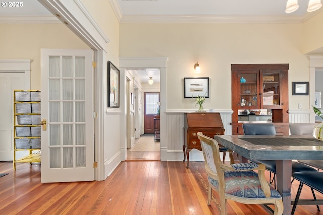 dining area featuring crown molding and hardwood / wood-style floors