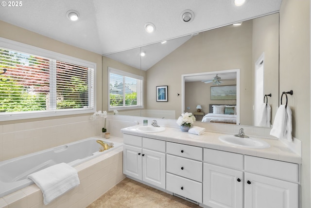 ensuite bathroom with a bath, recessed lighting, double vanity, lofted ceiling, and ceiling fan