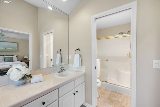 bathroom featuring a stall shower, toilet, vanity, lofted ceiling, and ensuite bathroom