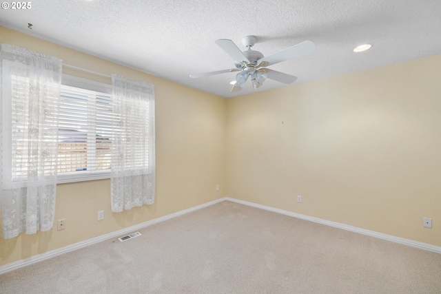 carpeted spare room with a ceiling fan, baseboards, a textured ceiling, and recessed lighting