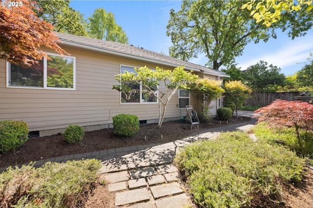 rear view of property featuring fence