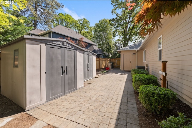 view of shed with fence