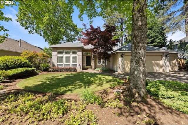 view of front of house with a garage, a front yard, concrete driveway, and brick siding