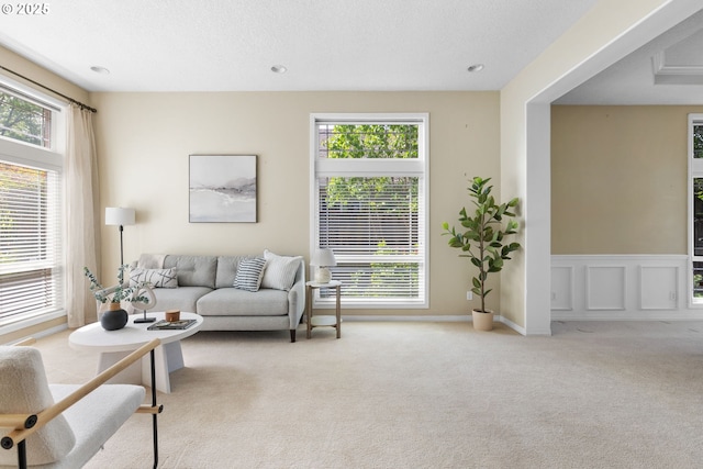 living room with light colored carpet and recessed lighting